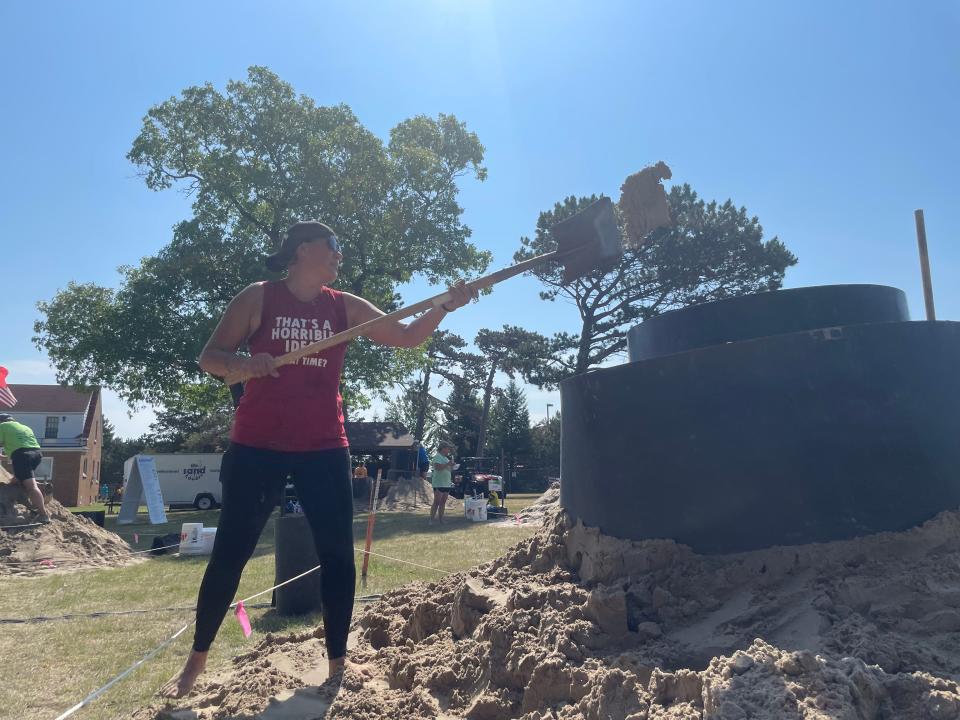 Dottie Willison of Sandusky, MI builds the foundation of her sand sculpture at SandFest. Her sculpture, "Fraya" will feature a peacock on a flower.