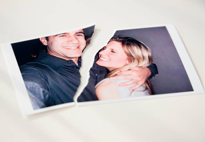 A torn photograph of a smiling couple, each with one arm around the other. The tear separates the image vertically between them