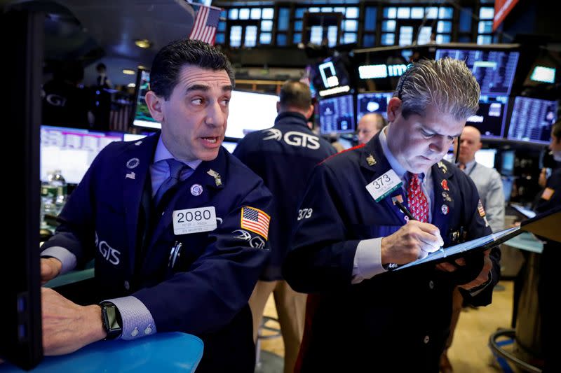 Traders work on the floor at the NYSE in New York