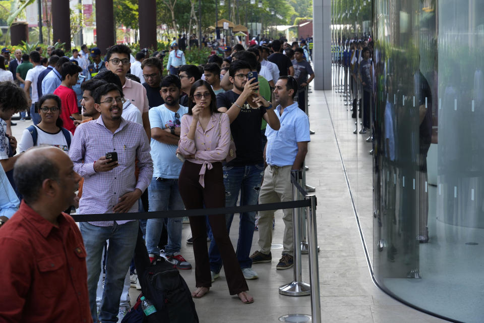 People line up outside during the opening of the first Apple Inc. flagship store in Mumbai, India, Tuesday, April 18, 2023. Apple Inc. opened its first flagship store in India in a much-anticipated launch Tuesday that highlights the company’s growing aspirations to expand in the country it also hopes to turn into a potential manufacturing hub. (AP Photo/Rafiq Maqbool)