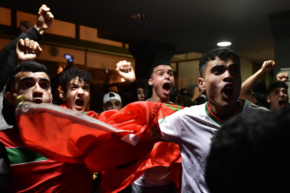 Morocco fans celebrate as they watch their team win the match against Spain at the World Cup soccer match tournament in Qatar, in Tudela, northern Spain, Tuesday, Dec. 6, 2022. (AP Photo/Alvaro Barrientos)