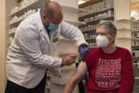 Pharmacist Brian Meyer gives Kay Ketzenberger the first dose of the Moderna COVID-19 vaccine on Tuesday, Jan. 5, 2021 at Sunflower Pharmacy in Odessa, Texas. The Moderna vaccine for the virus does not establish immunity until 7 to 14 days following the second dose according to the CDC. Sunflower Pharmacy is the first privately owned pharmacy in Odessa given to permission to distribute the vaccine. (Eli Hartman/Odessa American via AP)