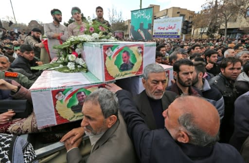Tens of thousands chanted "down with America" and "we will never submit" at the funeral of Revolutionary Guards killed in Wednesday's attack by a jihadist group Tehran accuses Pakistan of supporting