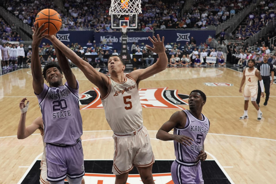 Kansas State forward Jerrell Colbert (20) and Texas forward Kadin Shedrick (5) compete for a rebound during the second half of an NCAA college basketball game Wednesday, March 13, 2024, in Kansas City, Mo. Kansas State won 78-74. (AP Photo/Charlie Riedel)