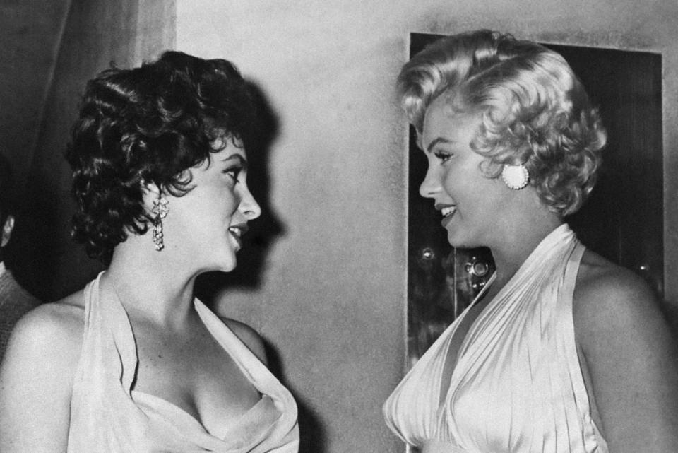 American actress Marilyn Monroe (R) talks to Italian actress Gina Lollobrigida (L) during a gala given in a New York theatre, in 1954 (AFP via Getty Images)