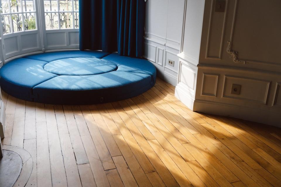 Deep blue modular seating inside Paris' renovated Gambetta apartment building.