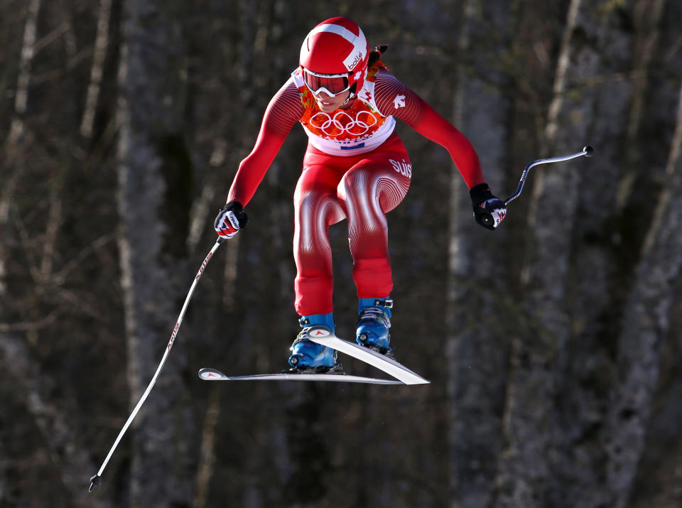 Switzerland's Dominique Gisin makes a jump in the women's downhill at the Sochi 2014 Winter Olympics, Wednesday, Feb. 12, 2014, in Krasnaya Polyana, Russia. (AP Photo/Alessandro Trovati)