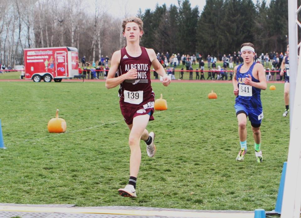 Albertus Magnus's Jake Harold finishes ninth in the boys state Class C cross-country championship, closely followed by Alden's Gage Feider Nov. 11, 2023 in Verona, New York.