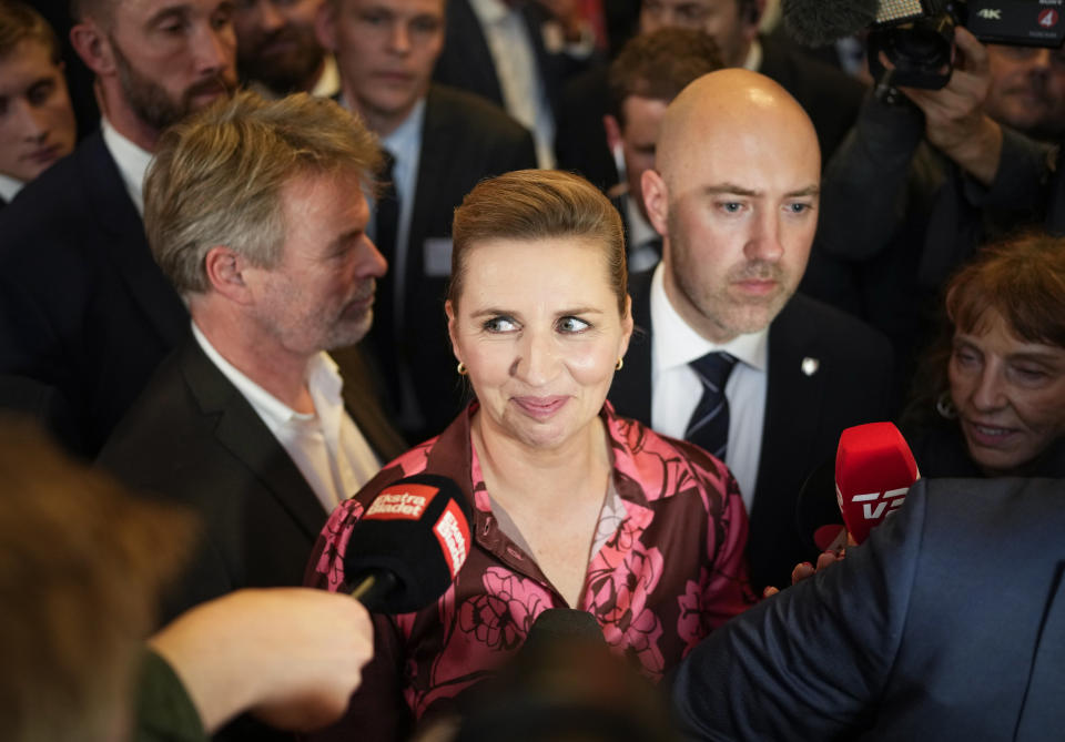 Denmark's Prime Minister and head of the Social Democratic Party Mette Frederiksen talks with media members after the country's general election night at the party in Copenhagen, Denmark, early Wednesday, Nov. 2, 2022. Frederiksen was in a strong position to remain in power after her Social Democrats won the most votes in Denmark election Tuesday and a center-left bloc in Parliament that backs appeared set to retain a majority by just one seat. (AP Photo/Sergei Grits)