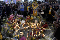 People gather at a memorial near Staples Center after the death of Laker legend Kobe Bryant Sunday, Jan. 26, 2020, in Los Angeles. (AP Photo/Michael Owen Baker)