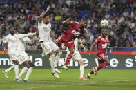 Brest's Steve Mounie, center, scores his side's first goal during a French League One soccer match between Lyon and Brest at the Groupama stadium, outside Lyon, France, Sunday, April 14, 2024. (AP Photo/Laurent Cipriani)