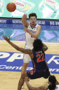 Kentucky's Devin Askew, top, passes over Auburn's Allen Flanigan (22) during the second half of an NCAA college basketball game in Lexington, Ky., Saturday, Feb. 13, 2021. (AP Photo/James Crisp)
