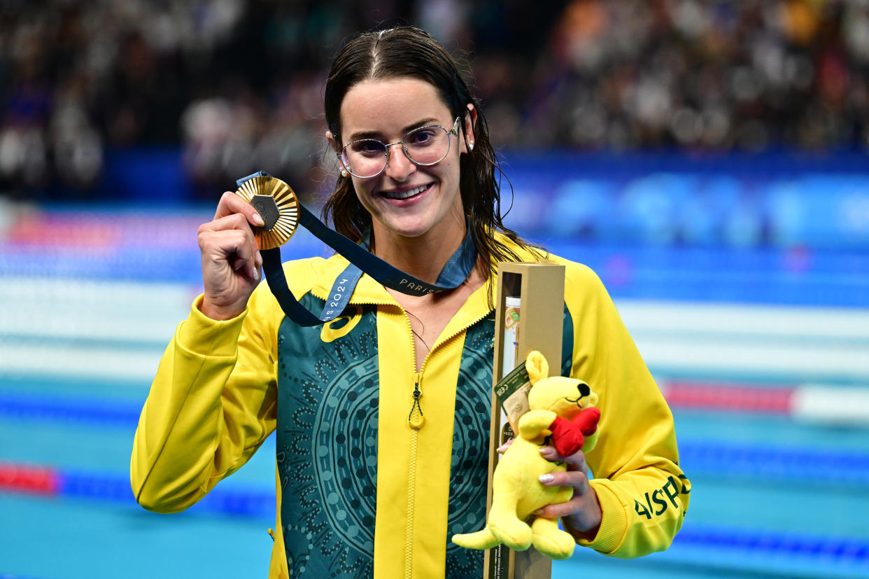 Gold medalist Kaylee McKeown of Team Australia celebrates during the award ceremony after the 100-meter backstroke at the 2024 Paris Olympics. (Christian Liewig/Getty Images)