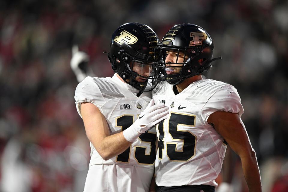 Nov 26, 2022; Bloomington, Indiana, USA;  Purdue Boilermakers running back Devin Mockobee (45) celebrates with wide receiver Charlie Jones (15) after scoring a touchdown against the Indiana Hoosiers during the second half at Memorial Stadium. Mandatory Credit: Marc Lebryk-USA TODAY Sports
