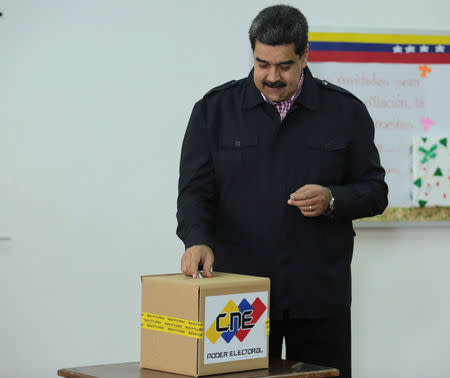 Venezuela's President Nicolas Maduro casts his vote at a polling station during the municipal legislators election in Caracas, Venezuela December 9, 2018. Miraflores Palace/Handout via REUTERS