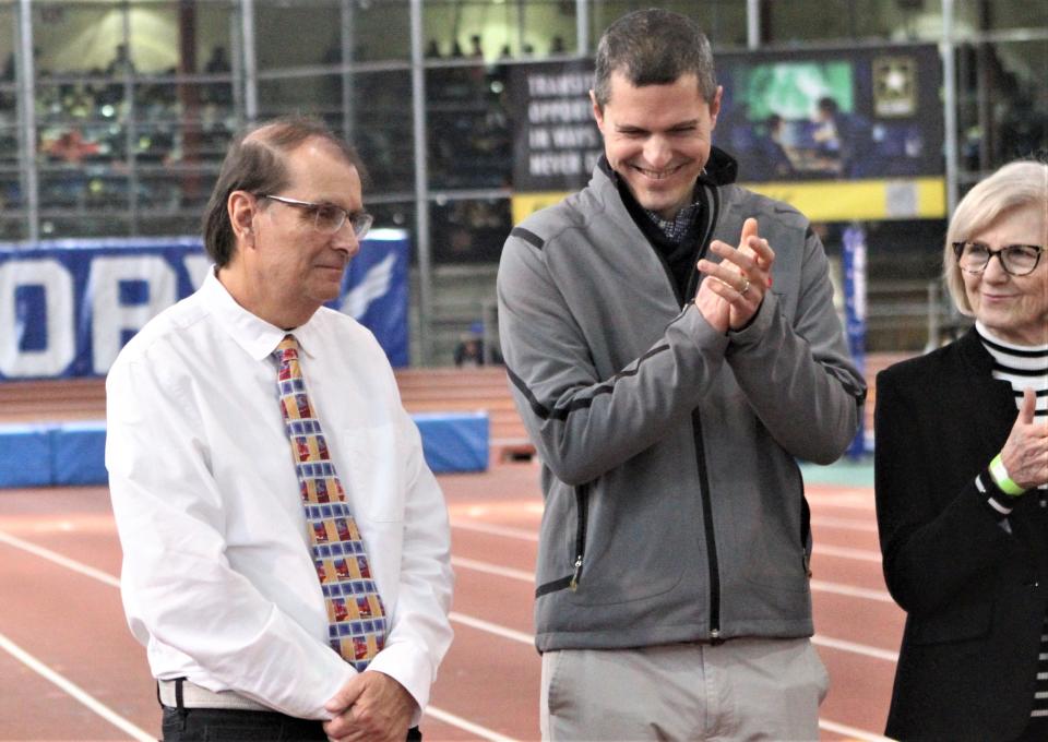 Pearl River resident John Nepolitan (l), a current, long-time track and field photographer and former Suffern High runner and former Albertus Magnus and Don Bosco running coach, is applauded by Derek Dye and his mother, Donna, after winning The Armory's Stan Saplin Award for outstanding track media contributions. Donna Dye and her late husband, John, were also Saplin Award winners, as was track announcer Ian Brooks. The ceremony took place January 21, 2022 during The Armory's 2023 U.S. Army Officials Hall of Fame Invitational track and field meet.