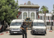 Police cars and a military armored personnel carrier block the entrance of the Tunisian parliament in Tunis, Tuesday, July 27, 2021. The Ennahda party, has called for dialogue, following President Kais Saeid's sacking of the prime minister and suspension of parliament on Sunday. (AP Photo/Hassene Dridi)