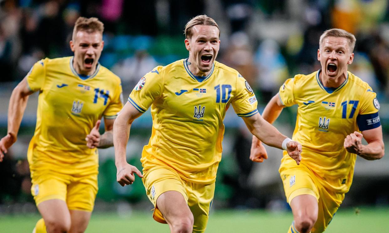 <span>Mykhailo Mudryk celebrates scoring the winning goal for Ukraine to seal their passage into Euro 2024.</span><span>Photograph: PressFocus/MB Media/Getty Images</span>