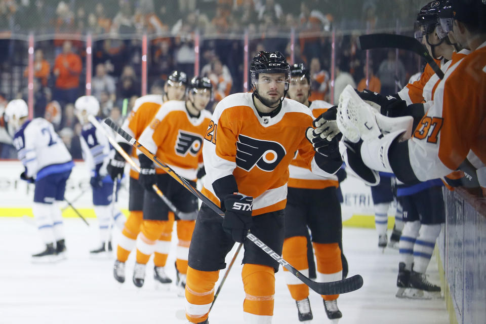 Philadelphia Flyers' Scott Laughton celebrates with teammates after scoring a goal during the first period of an NHL hockey game against the Winnipeg Jets, Saturday, Feb. 22, 2020, in Philadelphia. (AP Photo/Matt Slocum)