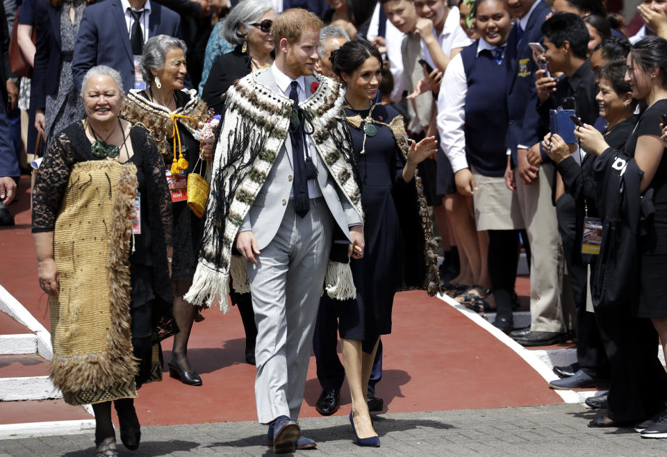 FILE - In this Oct. 31, 2018 file photo, Britain's Prince Harry and Meghan, Duchess of Sussex greet members of the public during their visit to Te Papaiouru Marae in Rotorua, New Zealand. Prince Harry and his wife, Meghan, are fulfilling their last royal commitment Monday March 9, 2020 when they appear at the annual Commonwealth Service at Westminster Abbey. It is the last time they will be seen at work with the entire Windsor clan before they fly off into self-imposed exile in North America. (AP Photo/Kirsty Wigglesworth, file)