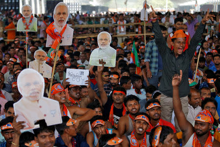 Supporters of Bharatiya Janata Party (BJP) react as they hold cut-outs of Prime Minister Narendra Modi during an election campaign rally addressed by Modi in Kolkata, April 3, 2019. REUTERS/Rupak De Chowdhuri/Files