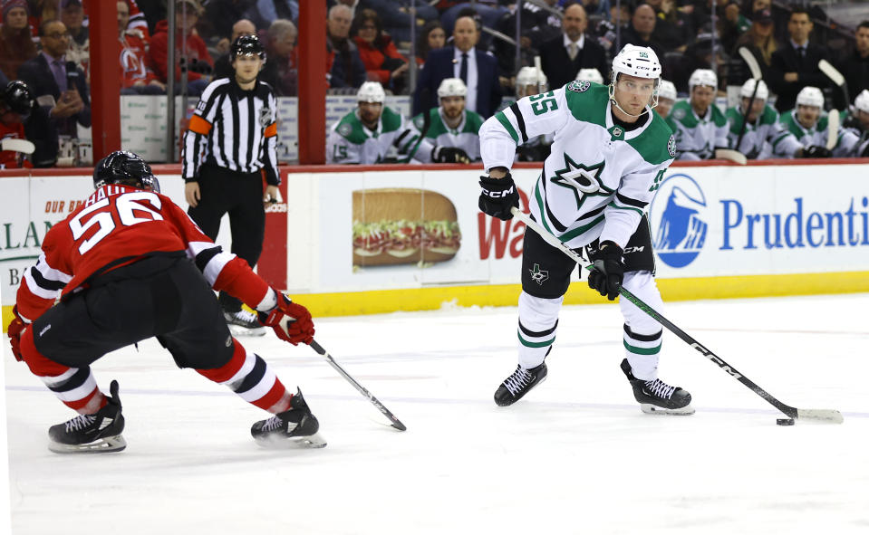 Dallas Stars defenseman Thomas Harley (55) skates with the puck against New Jersey Devils left wing Erik Haula (56) during the first period of an NHL hockey game Saturday, Jan. 20, 2024, in Newark, N.J. (AP Photo/Noah K. Murray)