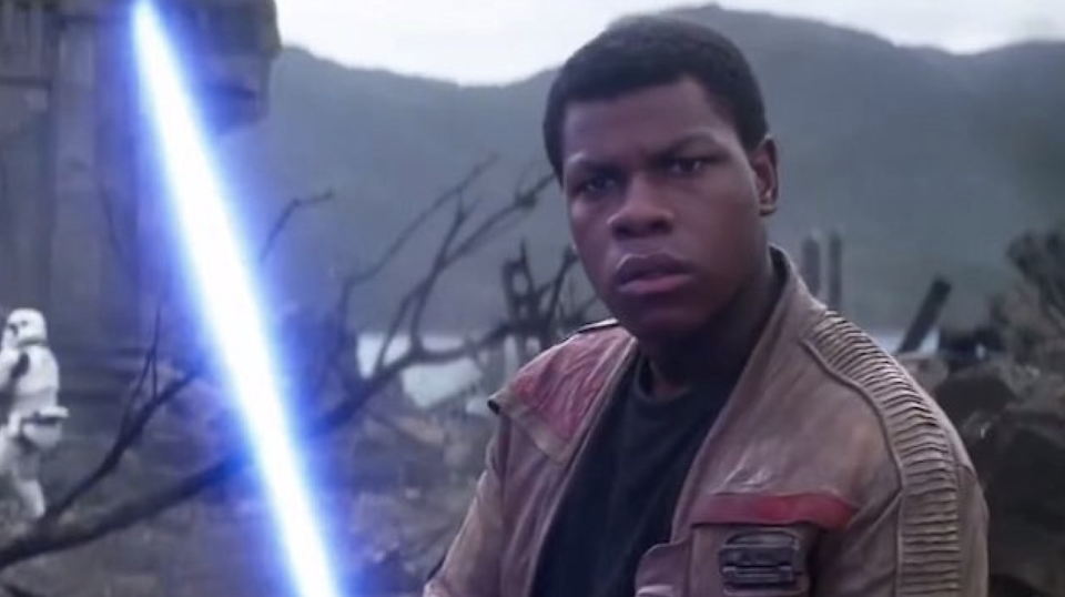 Finn with a blue Lightsaber in "Star Wars"