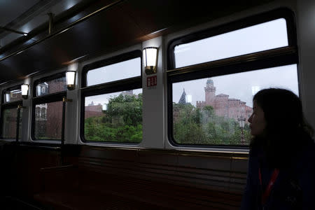 An employee sits onboard a train in the Huawei's Ox Horn campus at Songshan Lake in Dongguan, Guangdong province, China March 25, 2019. REUTERS/Tyrone Siu