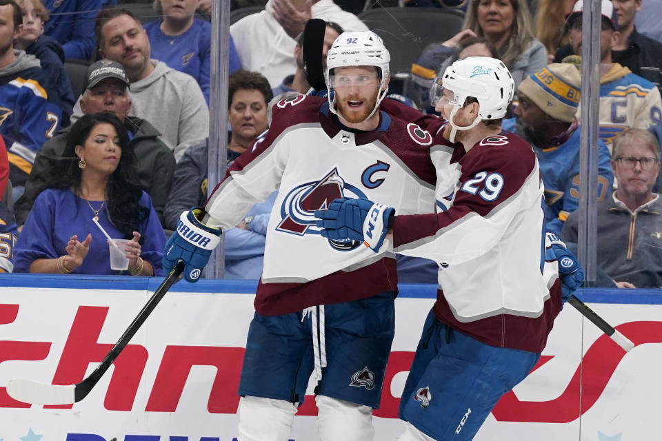 Colorado Avalanche's Gabriel Landeskog, left, is congratulated by teammate Nathan MacKinnon (29) after scoring during the third period in Game 3 of an NHL hockey Stanley Cup second-round playoff series against the St. Louis Blues Saturday, May 21, 2022, in St. Louis. (AP Photo/Jeff Roberson)