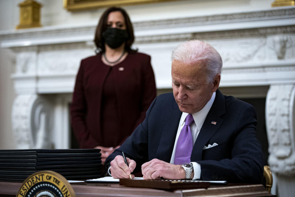 President Joe Biden signs an executive order with U.S. Vice President Kamala Harris (Al Drago/Bloomberg via Getty Images)