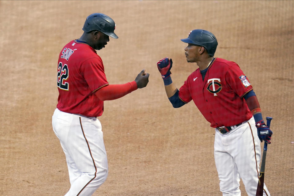 Minnesota Twins' Miguel Sano (22) and Jorge Polanco bump fists after Sano scored on an Andrelton Simmons double off New York Yankees pitcher Michael King during the fourth inning of a baseball game Thursday, June 10, 2021, in Minneapolis. (AP Photo/Jim Mone)