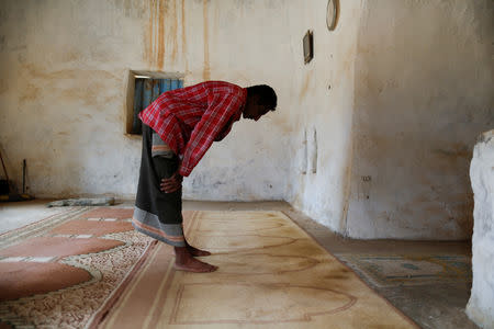 Hussein Abdu, 40, the father of ten-year-old malnourished girl Afaf Hussein, performs prayers at a mosque in the village of al-Jaraib, in the northwestern province of Hajjah, Yemen, February 19, 2019.EUTERS/Khaled Abdullah