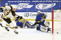 Buffalo Sabres goalie Dustin Tokarski (3) stops Boston Bruins forward Charlie Coyle (13) during the first period of an NHL hockey game, Tuesday, April 20, 2021, in Buffalo, N.Y. (AP Photo/Jeffrey T. Barnes)