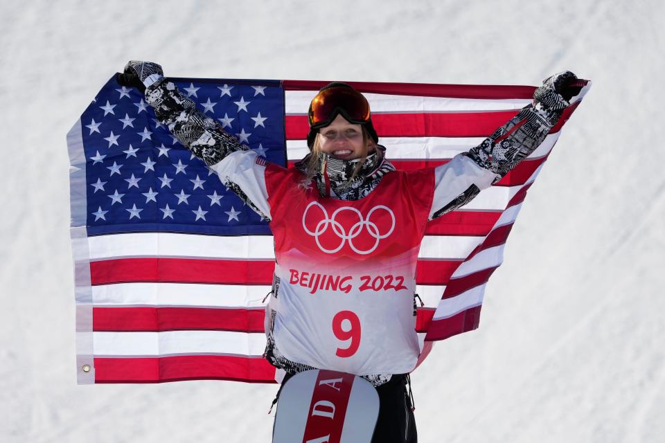 Silver medalist Julia Marino raises the American flag in the women's slopestyle snowboarding final during the Beijing 2022 Olympic Winter Games at Genting Snow Park.