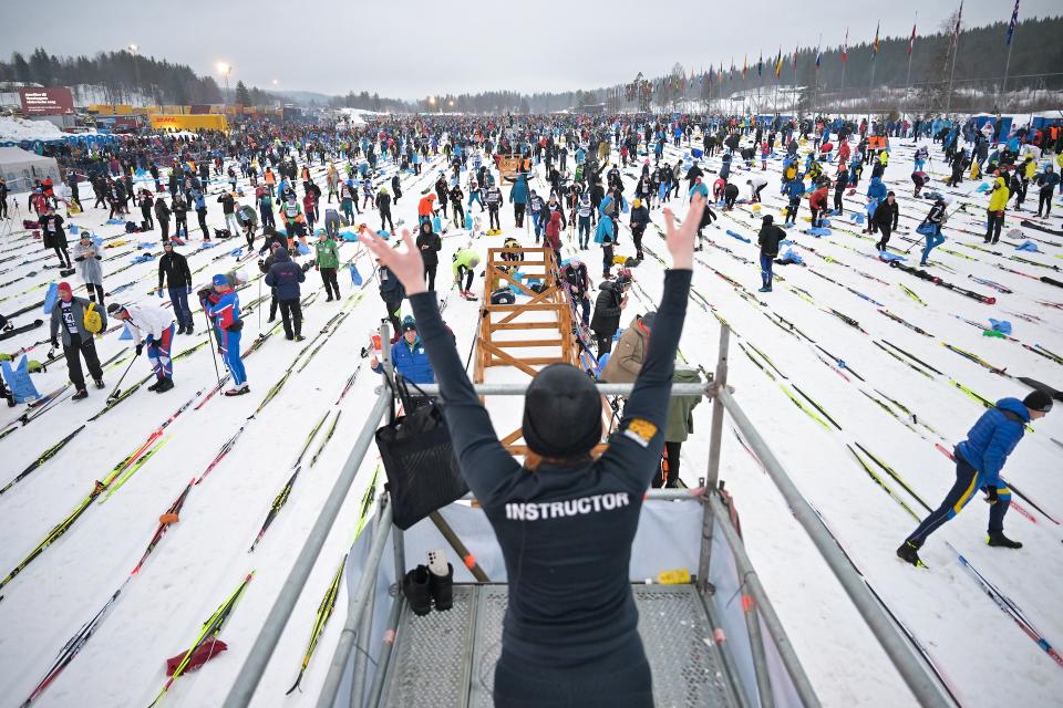 A fitness instructor leads a warm-up before the race. (Bjoern Reichert/NordicFocus/Getty Images)