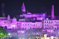 Hindu devotees gather while lighting earthen lamps on the banks of the River Sarayu on the eve before the groundbreaking ceremony of the proposed Ram Temple in Ayodhya on August 4, 2020. - India's Prime Minister Narendra Modi will lay the foundation stone for a grand Hindu temple in a highly anticipated ceremony at a holy site that was bitterly contested by Muslims, officials said. (Photo by SANJAY KANOJIA / AFP)