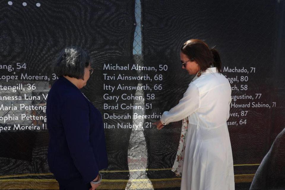 Ronit Felszer, right, stands with Miami-Dade County Mayor Daniella Levine Cava on May 12, 2022, as she points out the name of her son, Ilan Naibryf, 21, a University of Chicago student who died in the collapse of the Champlain Towers South condo in Surfside on June 24, 2021.