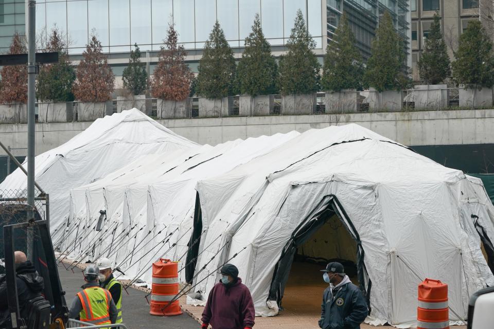 Workers build a makeshift morgue outside of Bellevue Hospital to handle an expected surge in coronavirus victims on March 25, in New York. Trump declared the beginning of the end of the coronavirus crisis in the U.S. on Tuesday and called for a quick end to social distancing, even as New York's governor compared the growing pandemic to a "bullet train." (Photo: BRYAN R. SMITH via Getty Images)