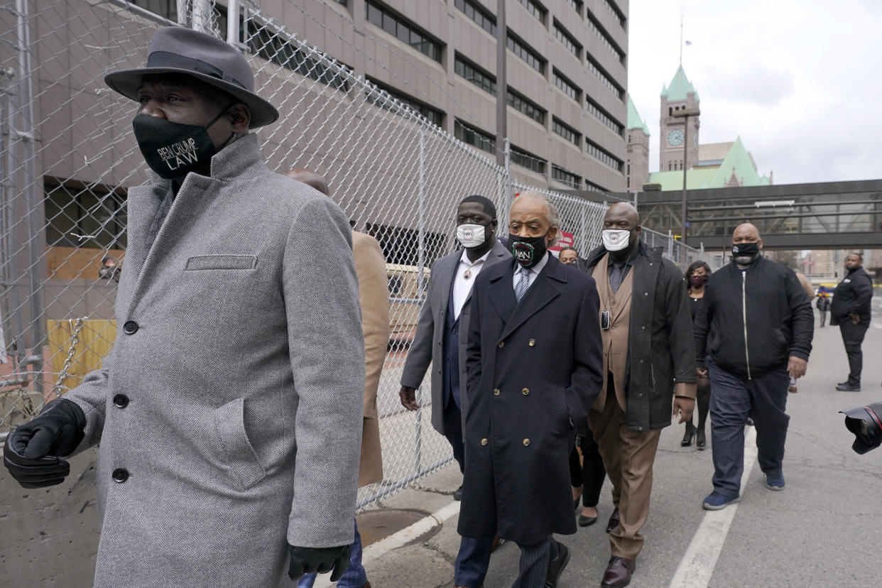 FILE - In this Monday, April 19, 2021 file photo, Ben Crump, left, attorney representing George Floyd's family, walks with the Rev. Al Sharpton, center, and Floyd's brothers Terrence Floyd, center left, and Rodney Floyd, center right, outside of the Hennepin County Government Center in Minneapolis, before the murder trial against former Minneapolis police officer Derek Chauvin advances to jury deliberations. (AP Photo/Julio Cortez)