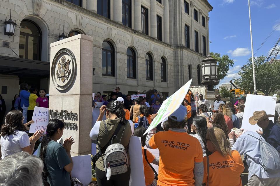 FILE - Opponents of an Iowa immigration law rally outside the federal courthouse on Monday, June 10, 2024, in downtown Des Moines, Iowa. A federal judge on Monday temporarily blocked an Iowa law that allows law enforcement in the state to file criminal charges against people with outstanding deportation orders or those who previously had been denied entry to the United States. (AP Photo/Scott McFetridge, File)