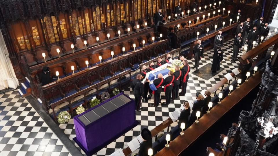 <div class="inline-image__caption"><p>Queen Elizabeth II (L) watches as pallbearers carry the coffin of Britain's Prince Philip, Duke of Edinburgh during his funeral inside St George's Chapel in Windsor Castle in Windsor, west of London, on April 17, 2021.</p></div> <div class="inline-image__credit">Dominic Lipinski / POOL / Getty</div>