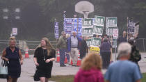 Voters walk past campaign volunteers at a polling place, Tuesday, Sept. 13, 2022, in Stratham, N.H. (AP Photo/Charles Krupa)