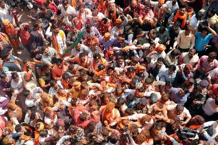 Supporters of Bharatiya Janata Party (BJP) celebrate after learning of the initial poll results at the party headquarters in Lucknow, India March 11, 2017. REUTERS/Pawan Kumar