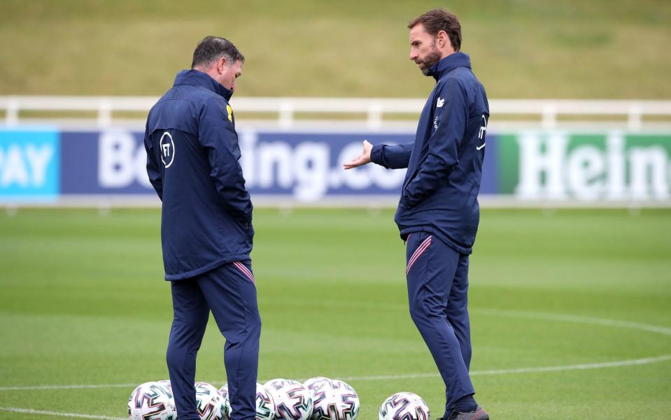 Gareth Southgate (R) and assistant Steve Holland during a training session at St George's Park - PA