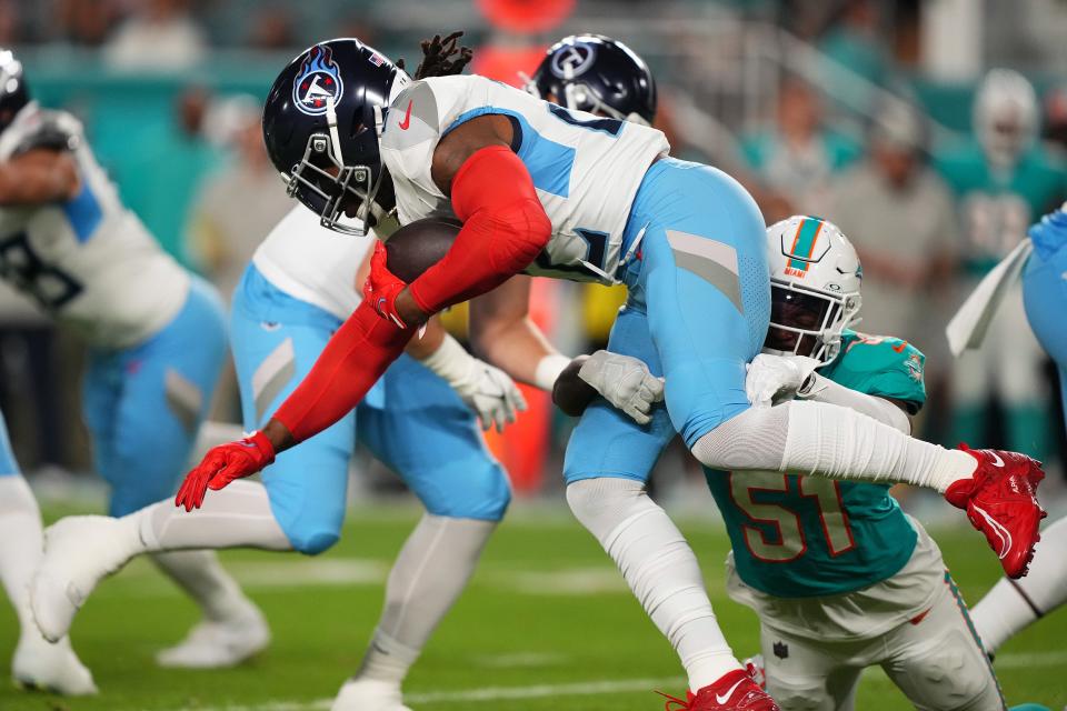 Miami Dolphins linebacker David Long Jr. (51) tackles Tennessee Titans running back Derrick Henry.