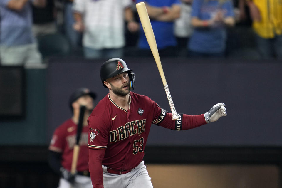 Arizona Diamondbacks' Christian Walker tosses his bat after hitting a fly out against the Texas Rangers during the 10th inning in Game 1 of the baseball World Series Friday, Oct. 27, 2023, in Arlington, Texas. (AP Photo/Godofredo A. Vásquez)