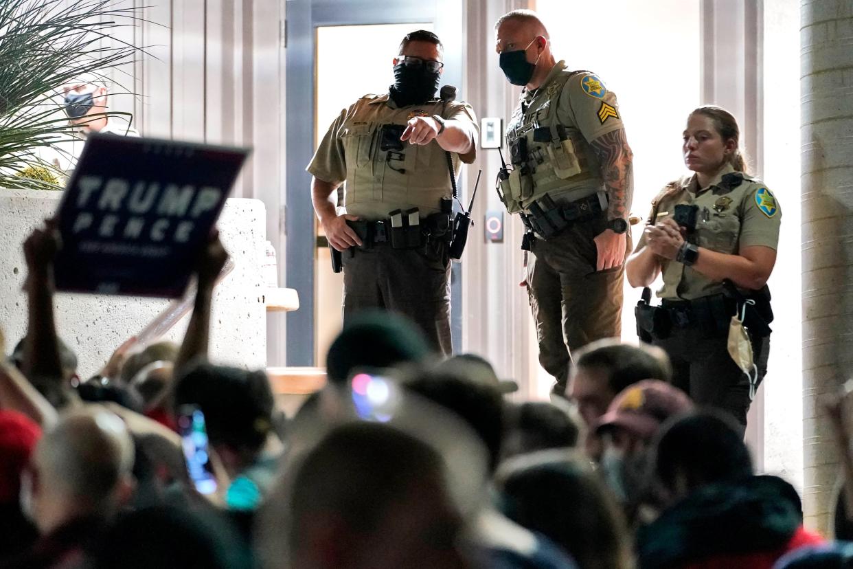 Maricopa County Sheriff's Deputies stand at the door of the Maricopa County Recorder's Office as President Donald Trump supporters rally outside, Wednesday, Nov. 4, 2020, in Phoenix. (AP Photo/Matt York) (AP)