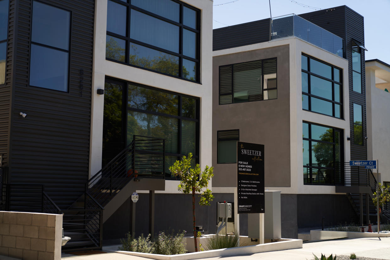 LOS ANGELES, CA - SEPTEMBER 22: A 'for sale' sign is displayed  in front of a new townhouse style home on September 22, 2022 in Los Angeles, California. The U.S. housing market is seeing a slow down in home sales due to the Federal Reserve raising mortgage interest rates to help fight inflation. (Photo by Allison Dinner/Getty Images)