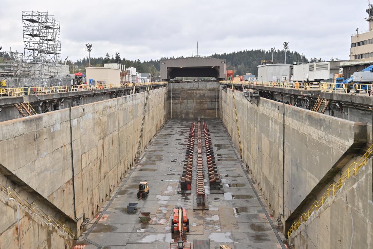 A photograph of the dry dock at Trident Refit Facility Bangor (TRFB). The dry dock is used to conduct hull maintenance on ballistic missile submarines and other work requiring a submarine to be out of the water. TRFB employs more than 2,000 civilian & military personnel in support of our nation’s strategic deterrent mission by repairing, incrementally overhauling, and modernizing ballistic missile submarines in the Pacific Fleet.