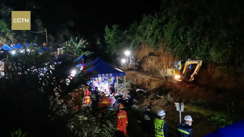 Rescuers work at the plane crash site in Wuzhou